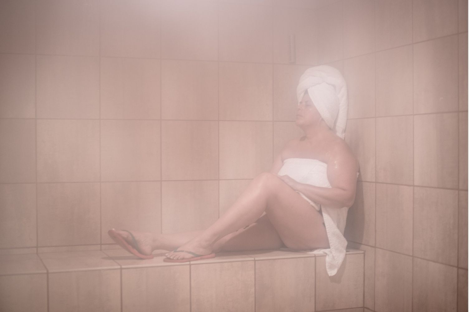Woman in sauna acclimating to heat